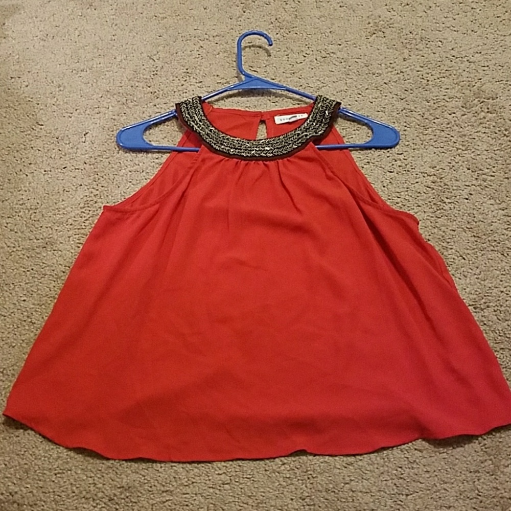 Red sleeveless flowing shirt